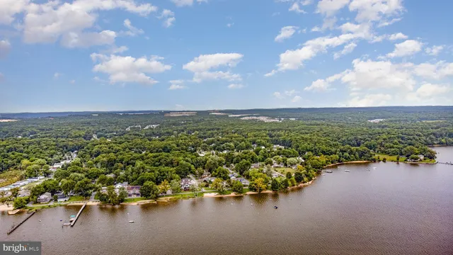 an aerial view of a houses with ocean view