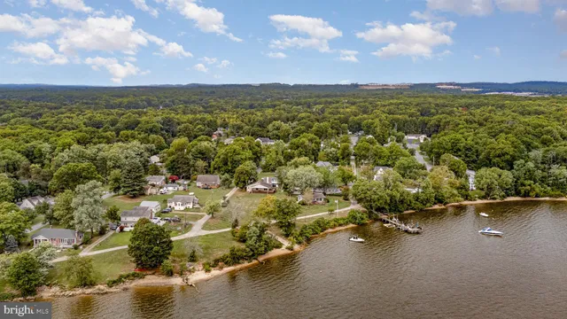 an aerial view of a houses with a lake view
