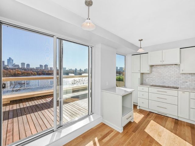 a large white kitchen with a large window