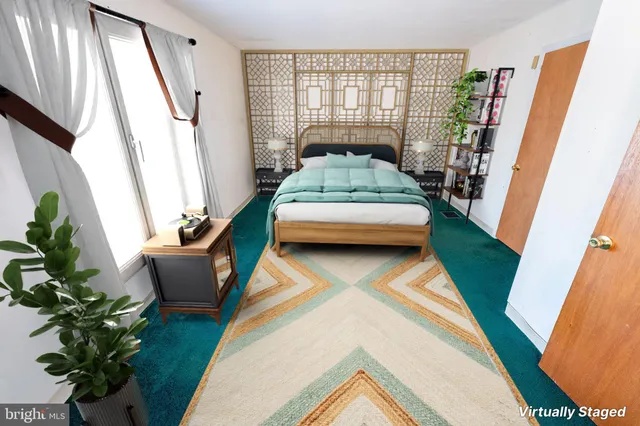 a bedroom with furniture and a potted plant