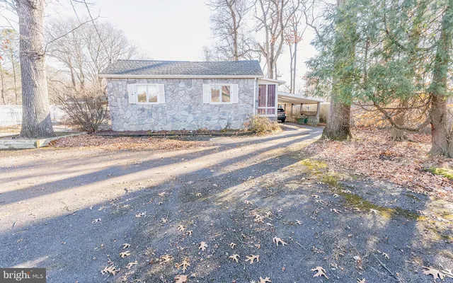 a view of a house with a yard and street