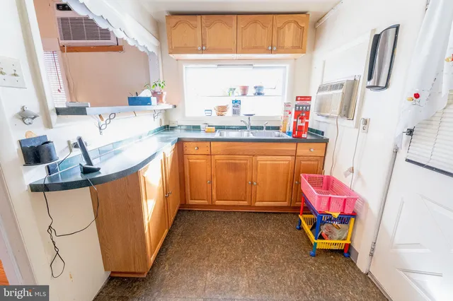 a kitchen with granite countertop a sink appliances and cabinets