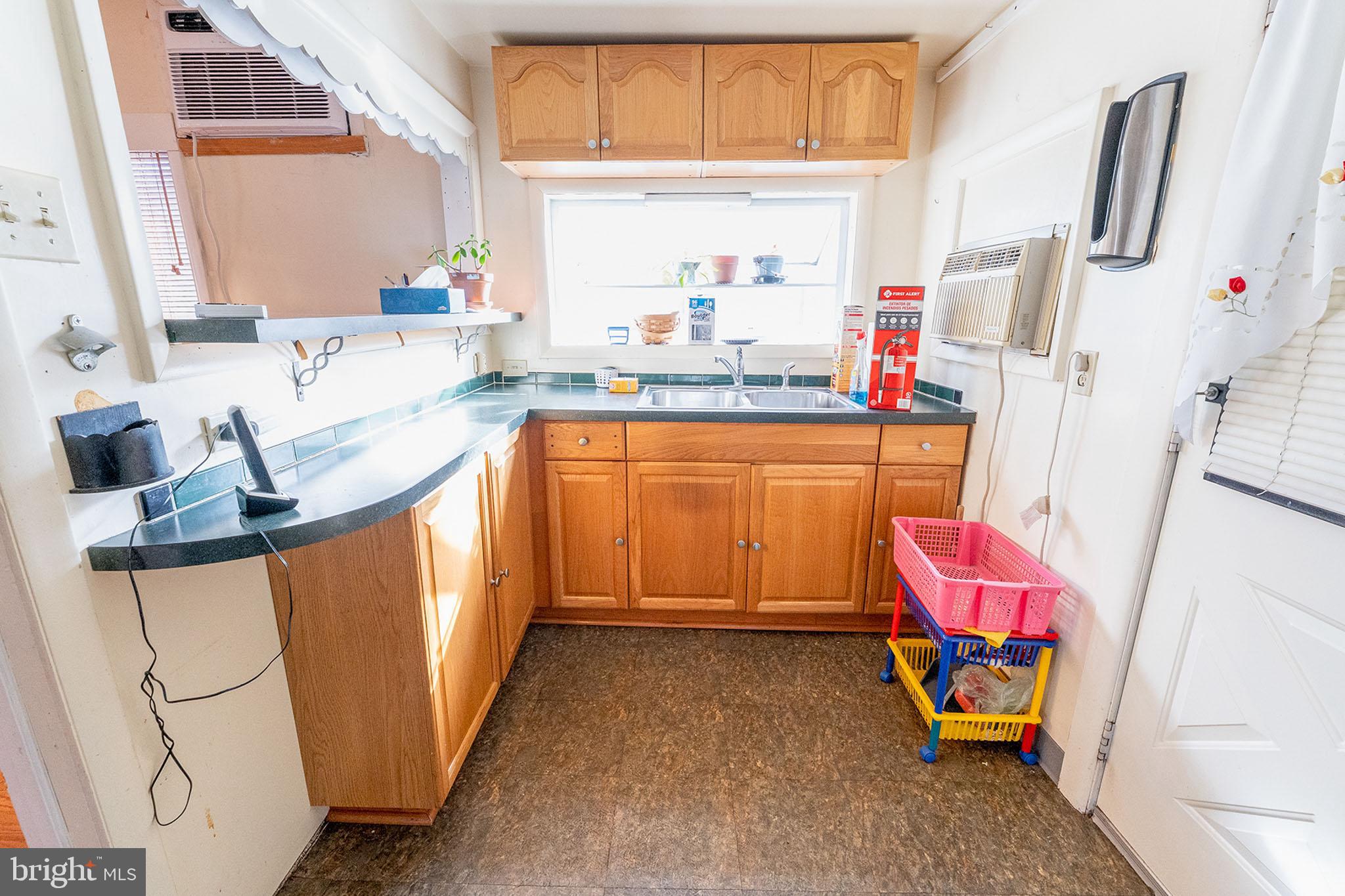 513 Eggert Crossing Road Ewing, NJ 08638 - Photo 23 of 36 a kitchen with granite countertop a sink appliances and cabinets