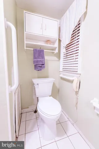 a white toilet sitting next to a bathroom sink