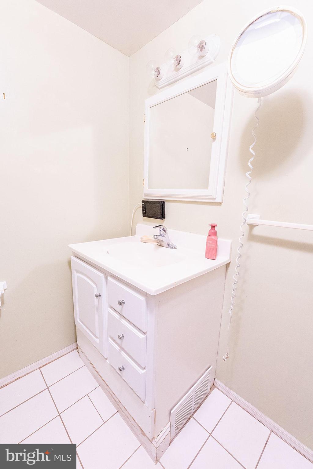 513 Eggert Crossing Road Ewing, NJ 08638 - Photo 29 of 36 a bathroom with a sink vanity and a mirror