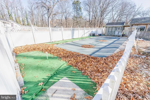 a view of a backyard with wooden fence