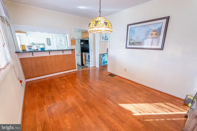 a view of a room with window and wooden floor