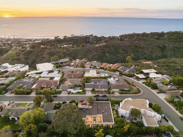 a living room with furniture a rug and kitchen chandelier
