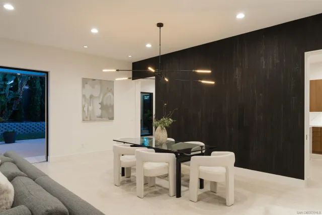 a kitchen with stainless steel appliances kitchen island granite countertop a refrigerator and a sink