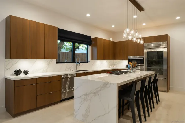 a view of a dining room with furniture and a chandelier