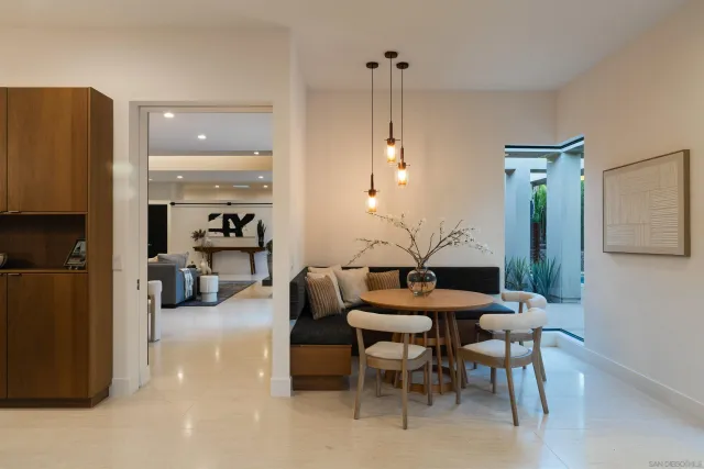 a bathroom with a double vanity sink a large mirror and a bathtub