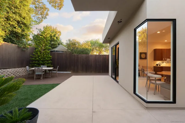 a living room with patio furniture and a potted plants