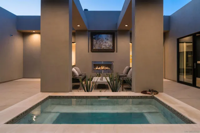 a bedroom with furniture and large windows