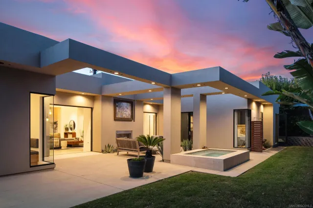 a view of a house with patio and a yard