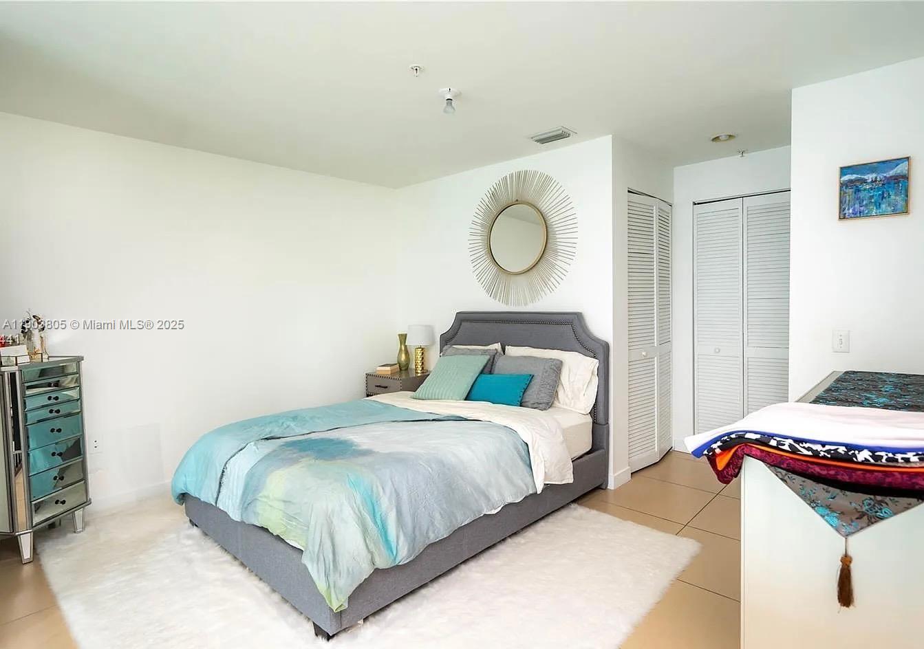 300 South Biscayne Boulevard, Unit L1208 Miami, FL 33131 - Photo 4 of 10 a bedroom with two beds and painting on the wall