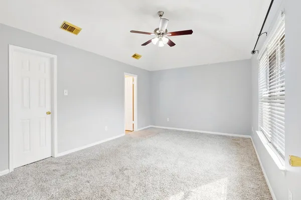 a view of an empty room with a window
