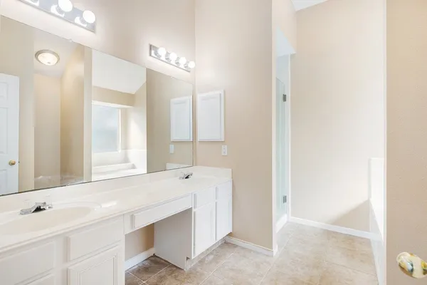 a bathroom with a sink vanity and a mirror