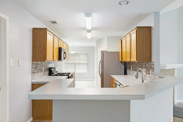 a kitchen with a sink a refrigerator and a sink