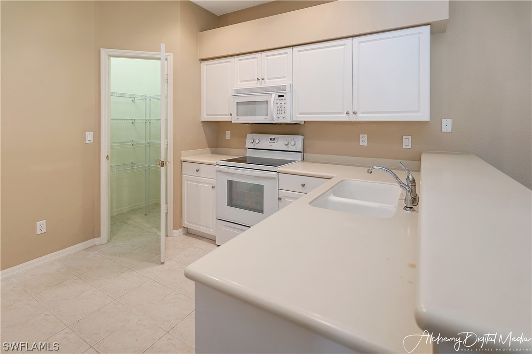 12625 Stone Valley Loop Fort Myers, FL 33913 - Photo 11 of 26 a kitchen with a stove a sink and a refrigerator