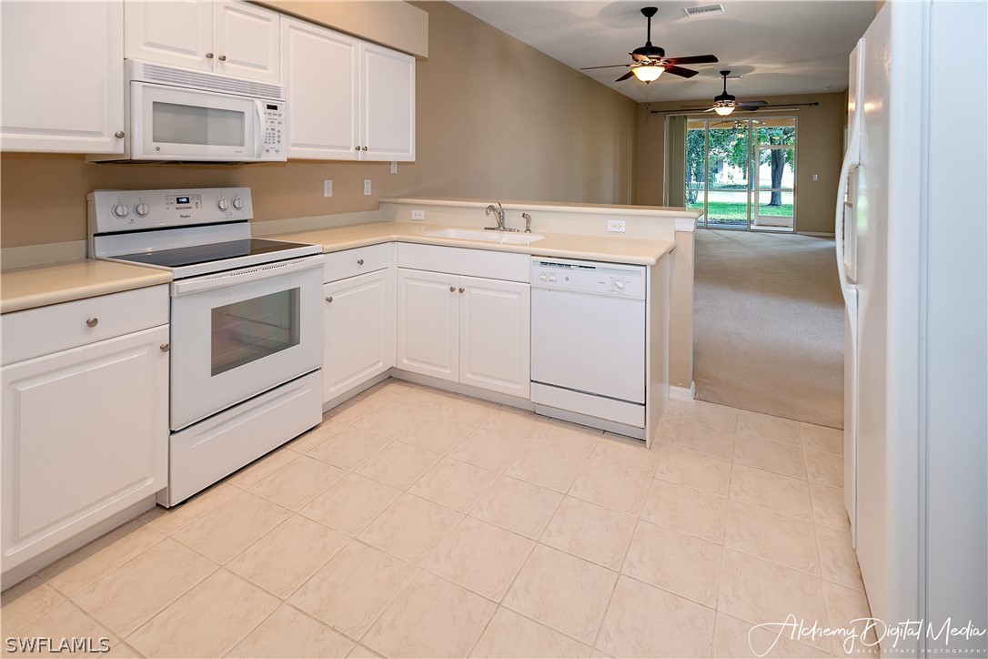 12625 Stone Valley Loop Fort Myers, FL 33913 - Photo 12 of 26 a kitchen with a stove cabinets and a sink