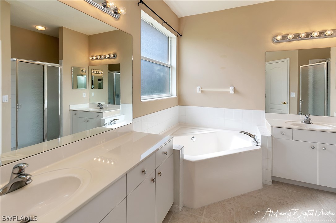 12625 Stone Valley Loop Fort Myers, FL 33913 - Photo 15 of 26 a spacious bathroom with a sink double vanity and a mirror