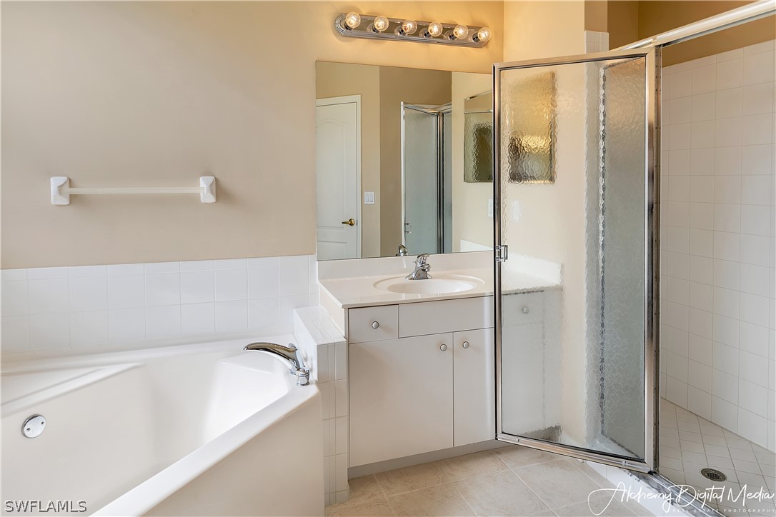 12625 Stone Valley Loop Fort Myers, FL 33913 - Photo 16 of 26 a bathroom with a tub a sink and mirror