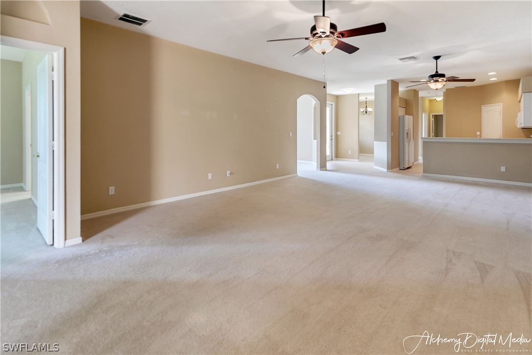 12625 Stone Valley Loop Fort Myers, FL 33913 - Photo 7 of 26 en empty room with windows and ceiling fan