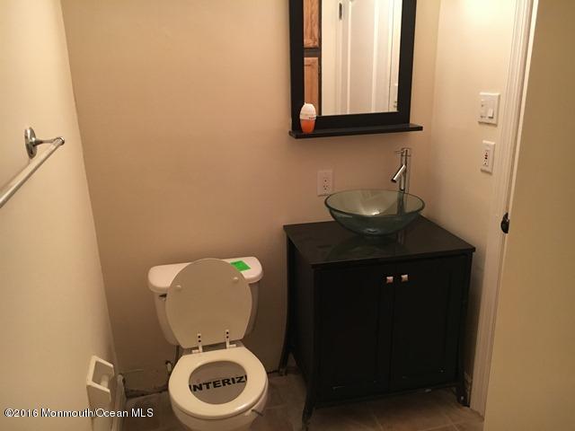 16 Windsor Road Howell, NJ 07731 - Photo 15 of 15 a bathroom with a toilet sink and mirror