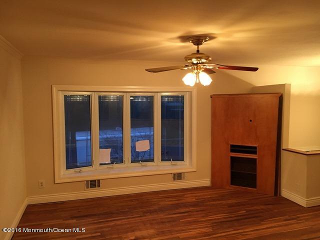16 Windsor Road Howell, NJ 07731 - Photo 7 of 15 a view of a livingroom with a ceiling fan and window
