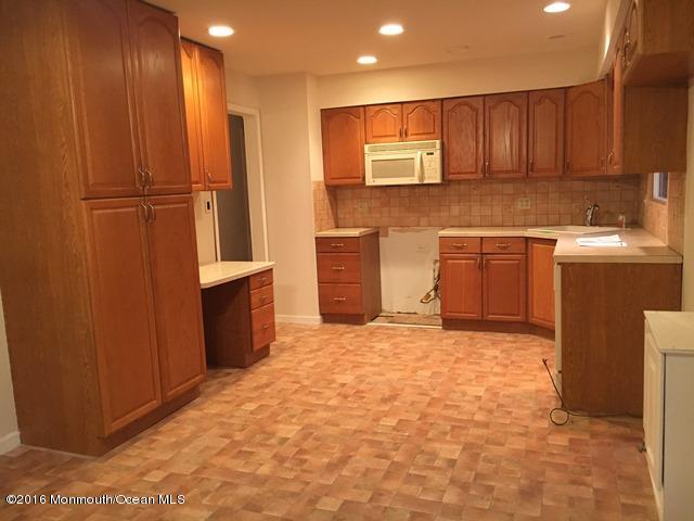 16 Windsor Road Howell, NJ 07731 - Photo 8 of 15 a kitchen with stainless steel appliances granite countertop a refrigerator and a stove top oven