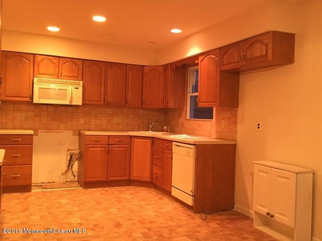 16 Windsor Road Howell, NJ 07731 - Photo 9 of 15 a kitchen with stainless steel appliances granite countertop a refrigerator a stove and a sink with wooden cabinets