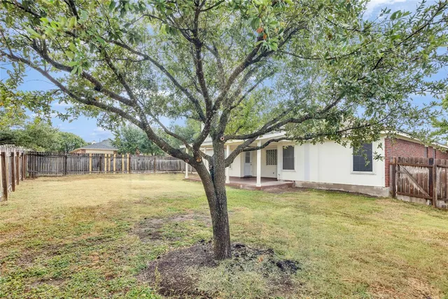 a house that has a tree in front of it
