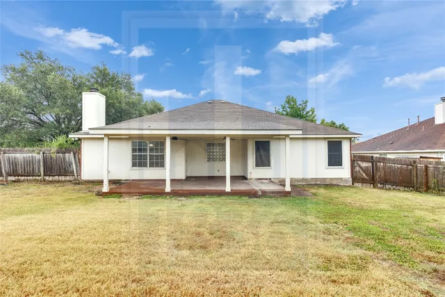 a view of a house with a yard and sitting area