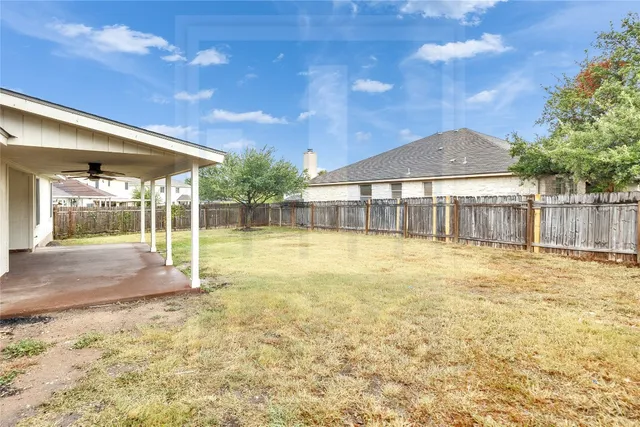 a view of a house with a backyard and a small yard