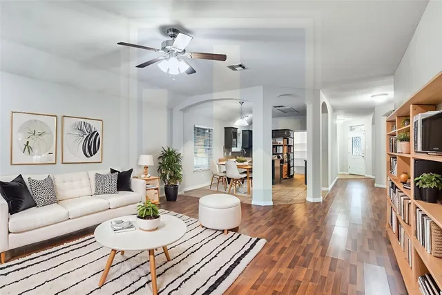 a living room with furniture and wooden floor