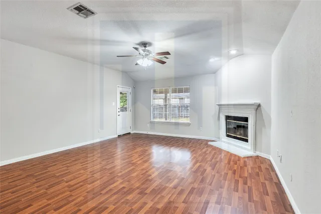 wooden floor in an empty room with a fireplace