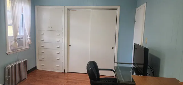 a view of a livingroom with furniture and a window