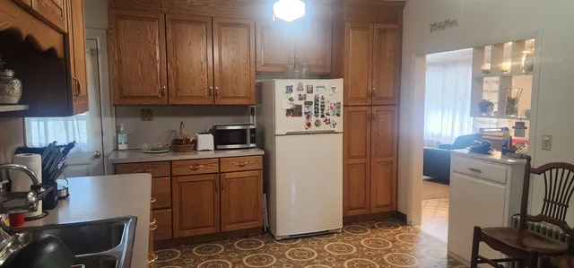 a kitchen with stainless steel appliances granite countertop a refrigerator and a stove top oven