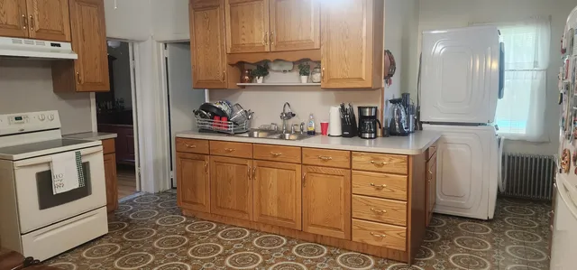 a kitchen with stainless steel appliances a refrigerator sink and cabinets