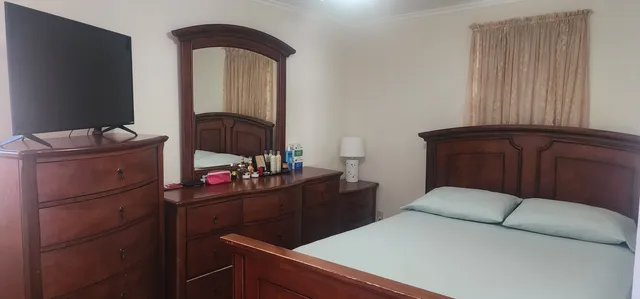 a bedroom with a bed and a dresser