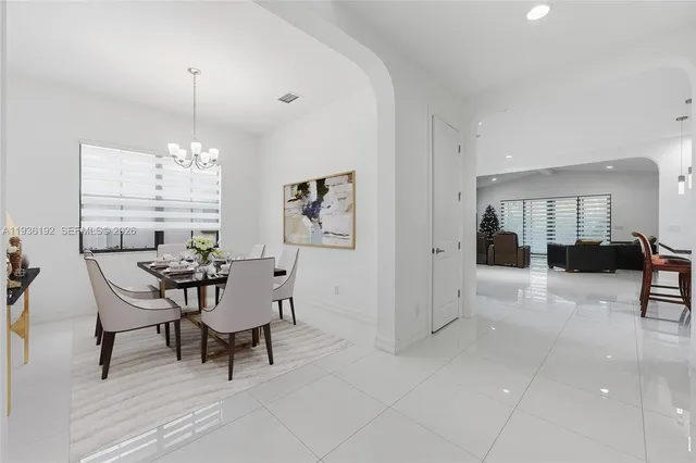 a view of a dining room with furniture and chandelier
