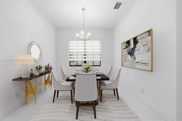 a view of a dining room with furniture a chandelier and wooden floor
