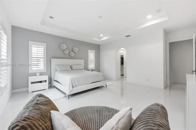 a bedroom with a large bed and a couch