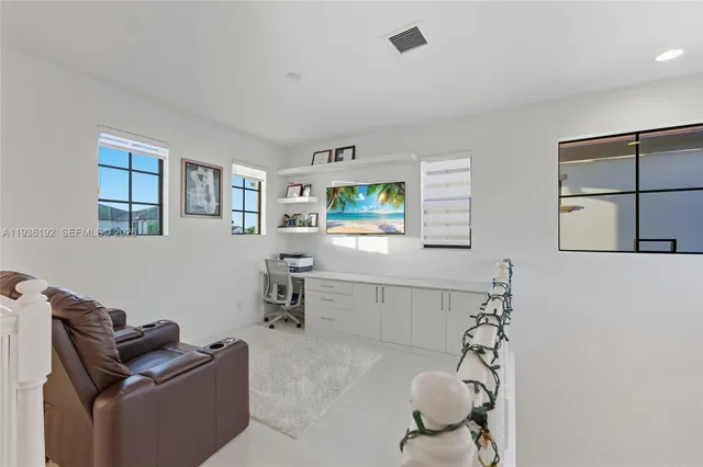a living room with furniture cabinets and window