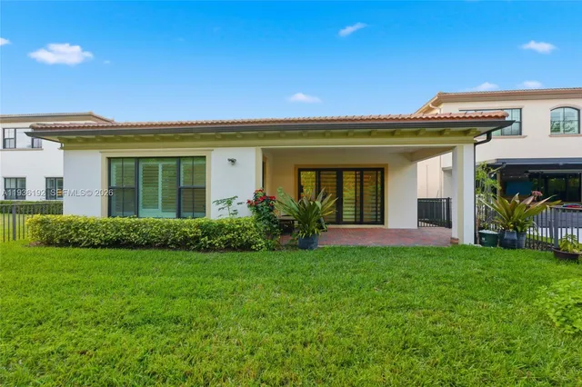 a view of an house with backyard space and garden