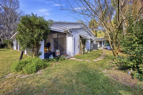 a backyard of a house with table and chairs