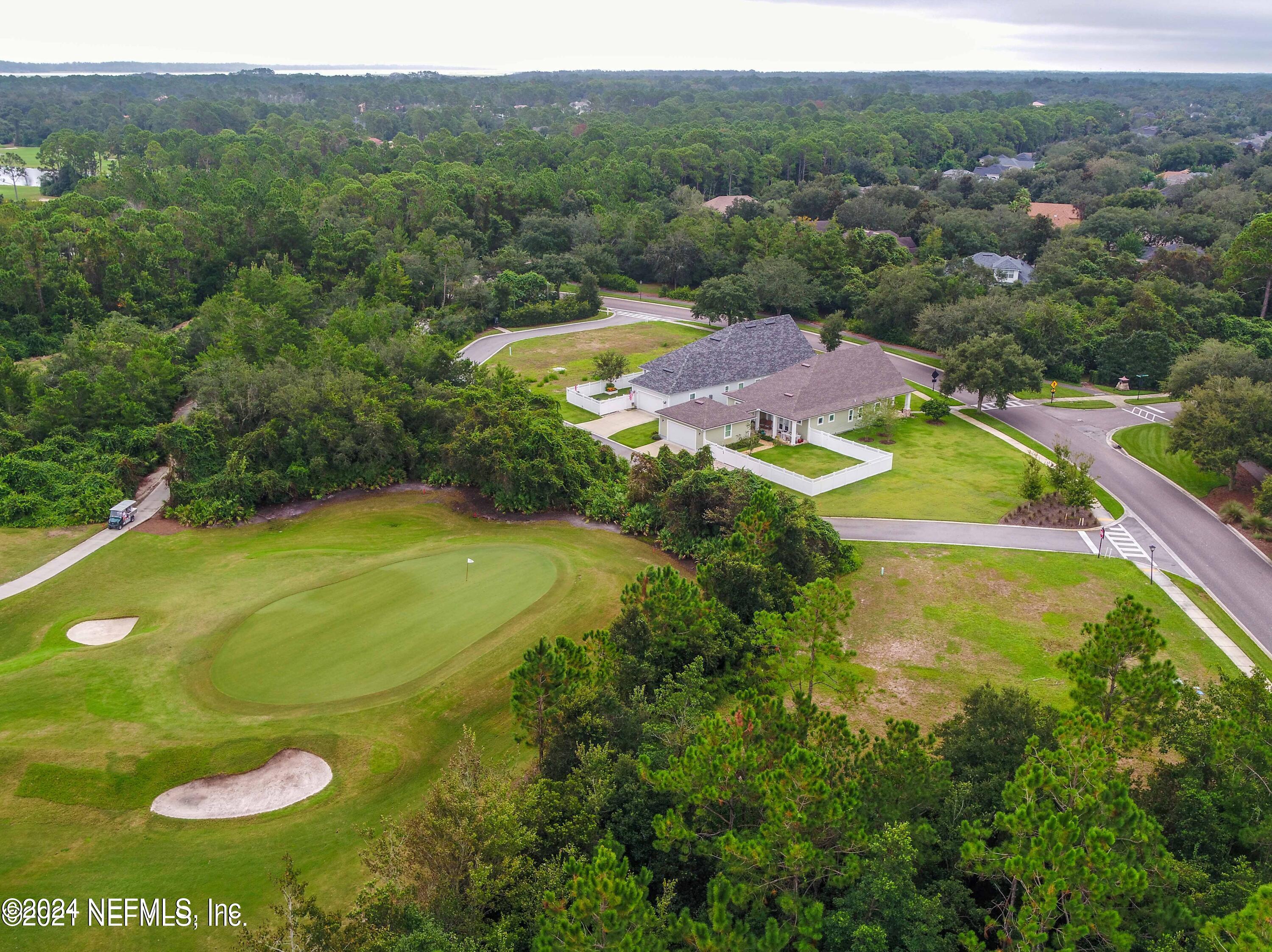 744 South Loop Parkway St. Augustine, FL 32095 - Photo 6 of 14 a view of a large pool with lawn chairs and large trees