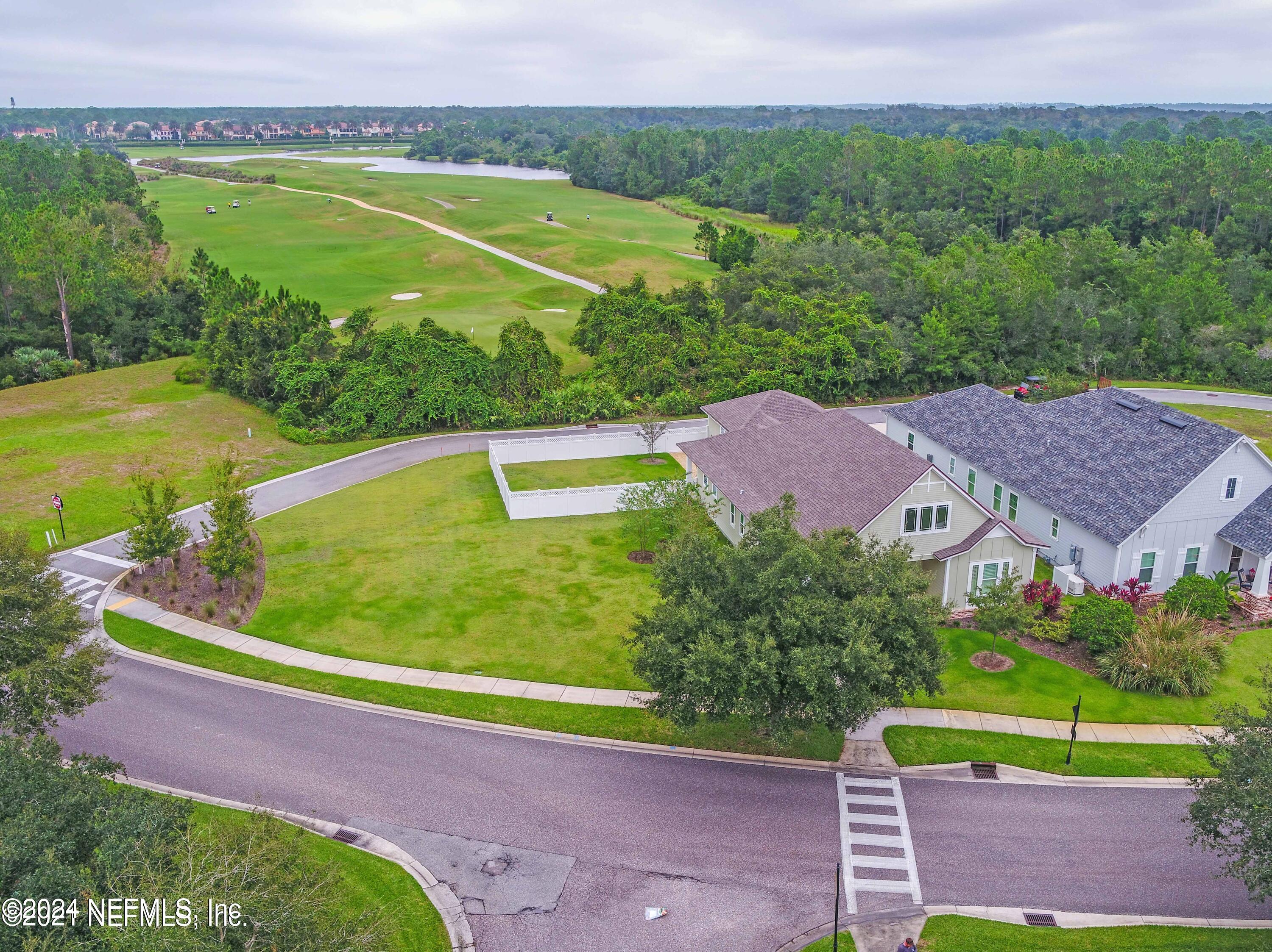 744 South Loop Parkway St. Augustine, FL 32095 - Photo 7 of 14 a view of a swimming pool with a yard and large tree