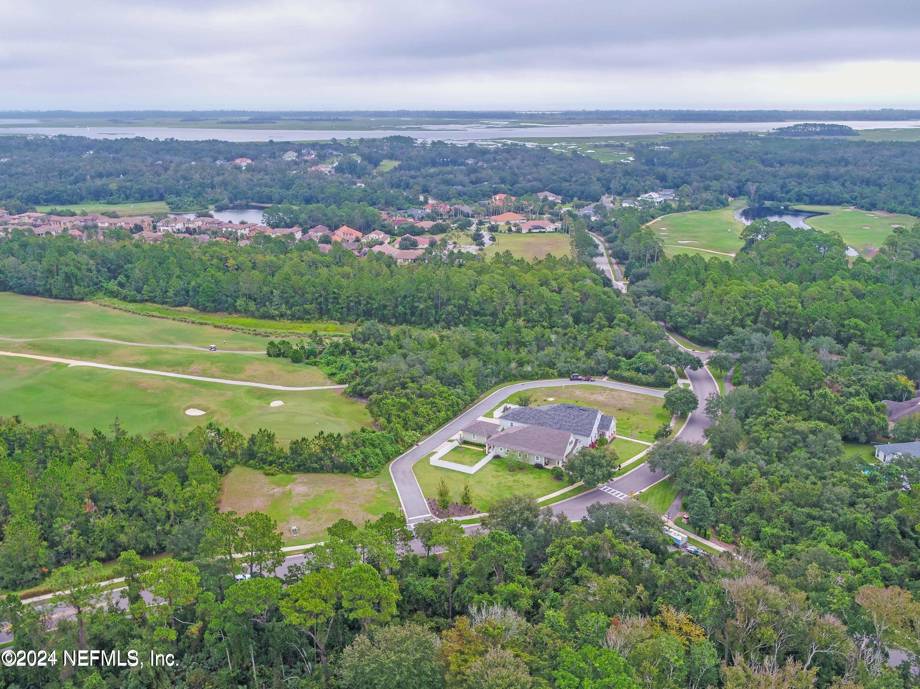 744 South Loop Parkway St. Augustine, FL 32095 - Photo 9 of 14 an aerial view of a house with a garden and lake view