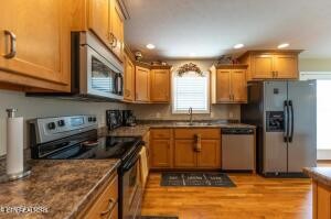 338 Pistole Road Sparta, TN 38583 - Photo 11 of 39 a kitchen with stainless steel appliances granite countertop a stove a sink and a refrigerator